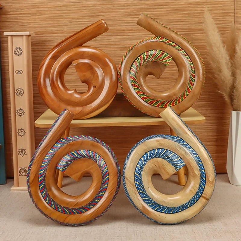 Four spiral wooden ornaments with woven patterns on a Portable Spiral Didgeridoo