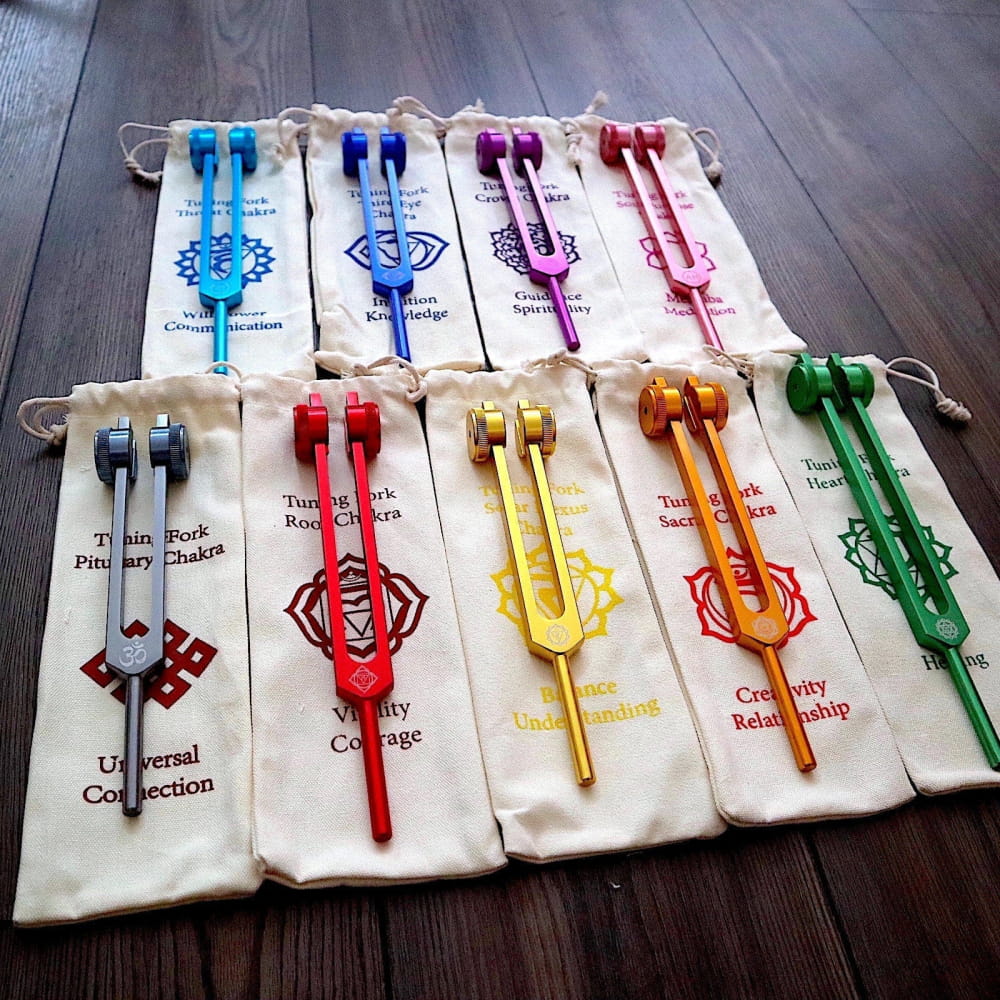 Colorful tuning forks in cloth pouches featuring Chakra symbols for healing energy