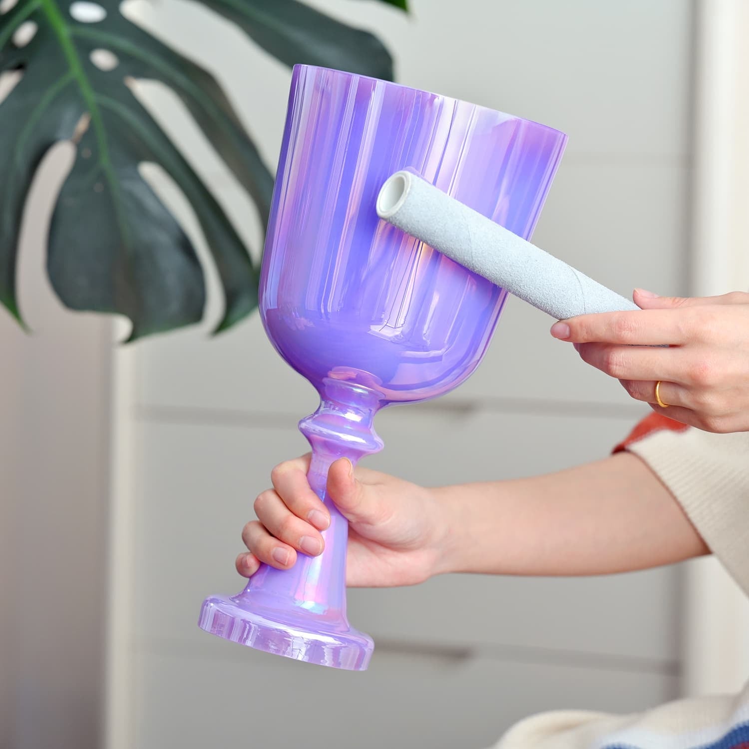 Purple Crystal Singing Chalice being hand-painted with a white brush for sound healing