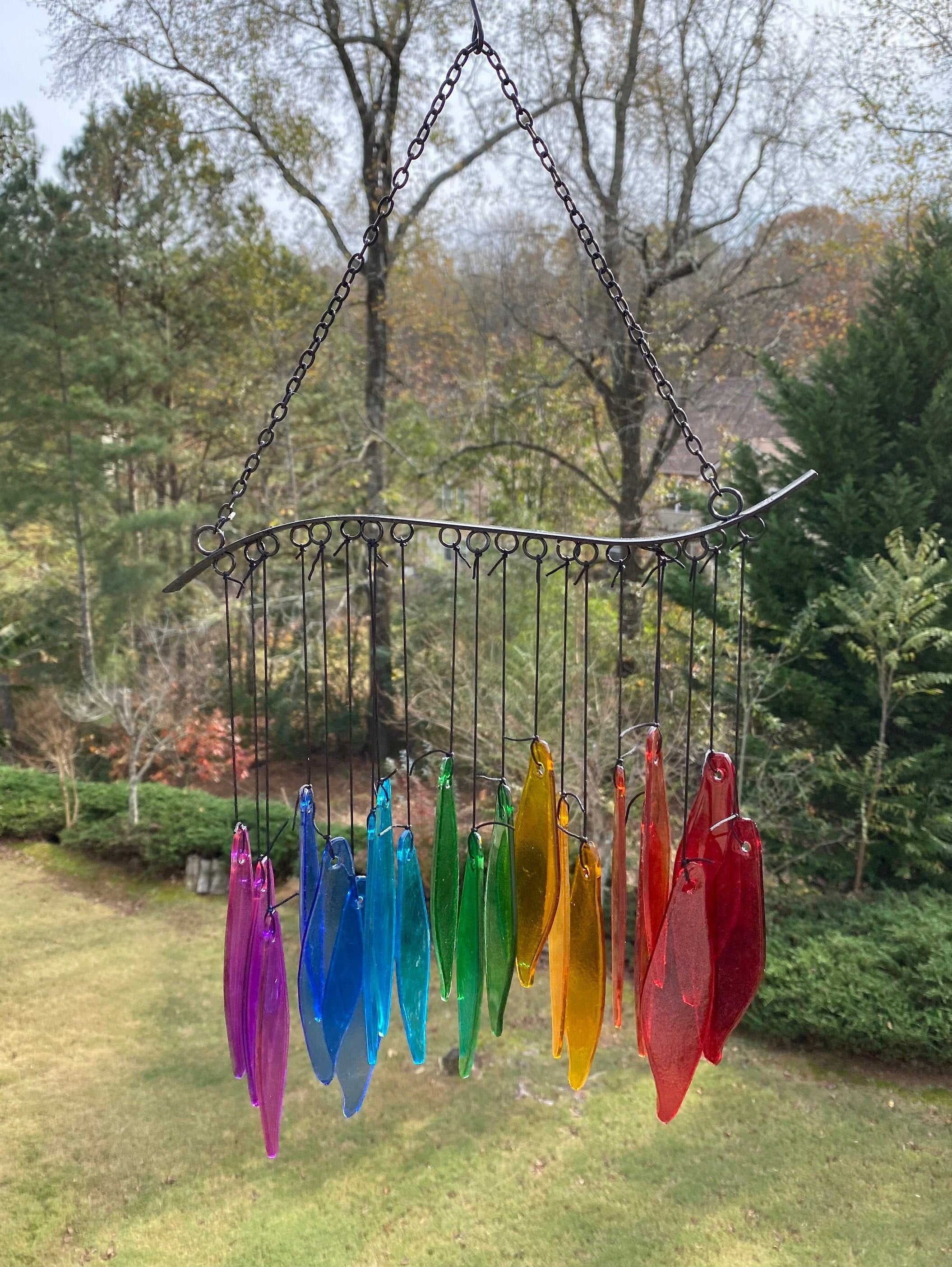 Rainbow Glass Wind Chimes featuring colorful glass feathers on a metal arch