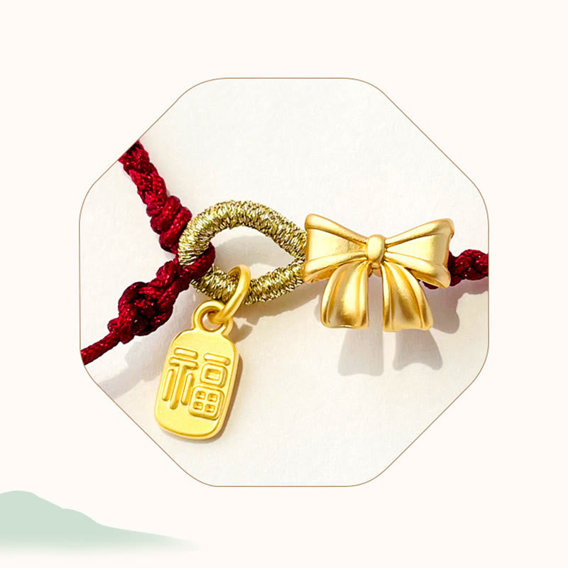 Bracelet en fil rouge avec breloque Fu et détail fleur de pêcher