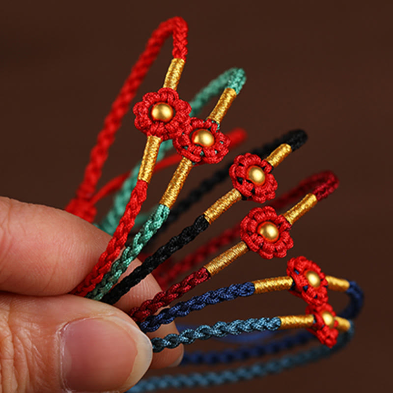 Bracelet de protection en fil rouge avec fleur dorée