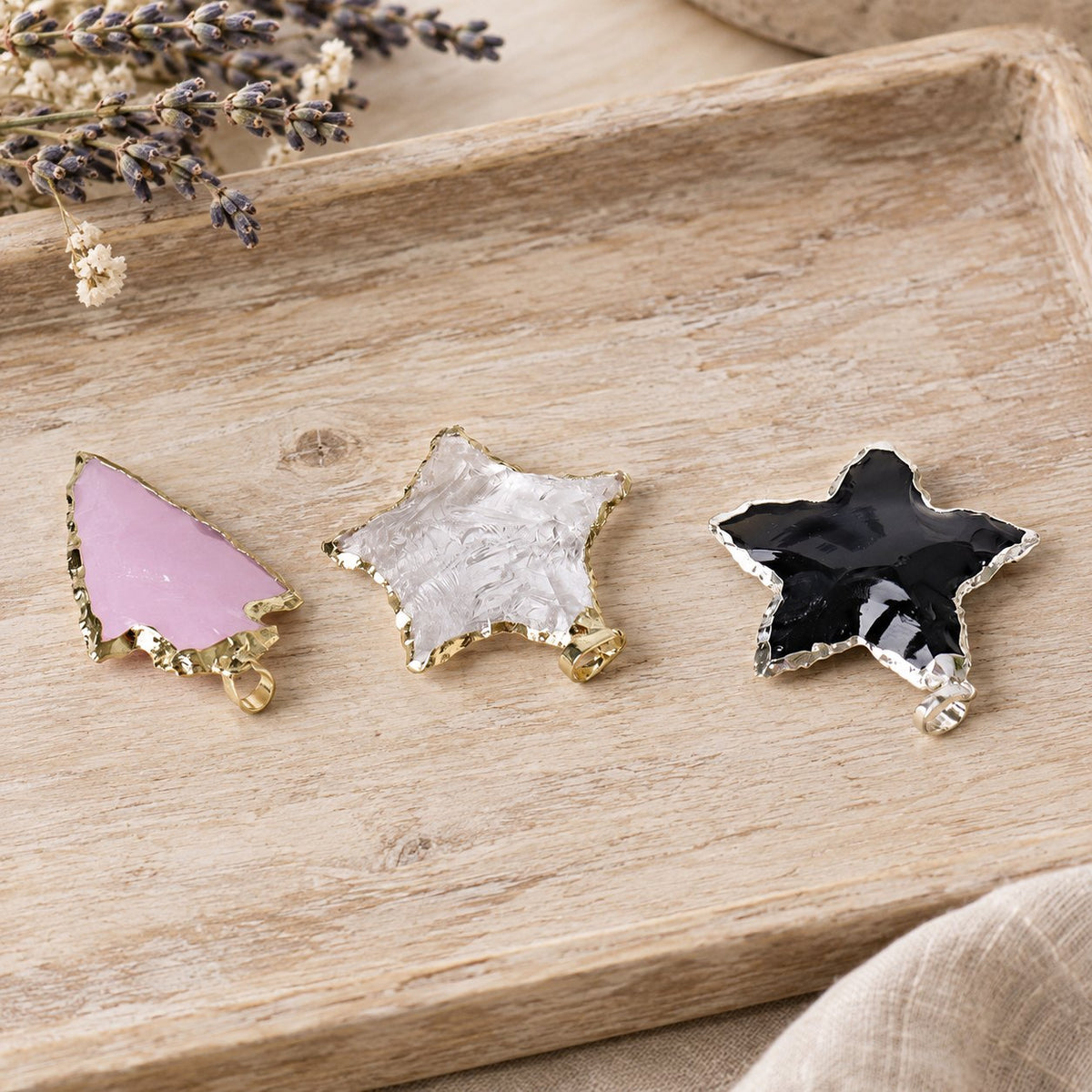Raw Rose Quartz, Black Obsidian & Clear Quartz Star Pendants 1 inch, all three pendants lying, low angle