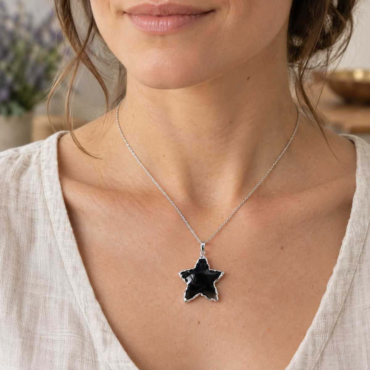 Raw Rose Quartz, Black Obsidian & Clear Quartz Star Pendants 1 inch, worn on the neck by a woman