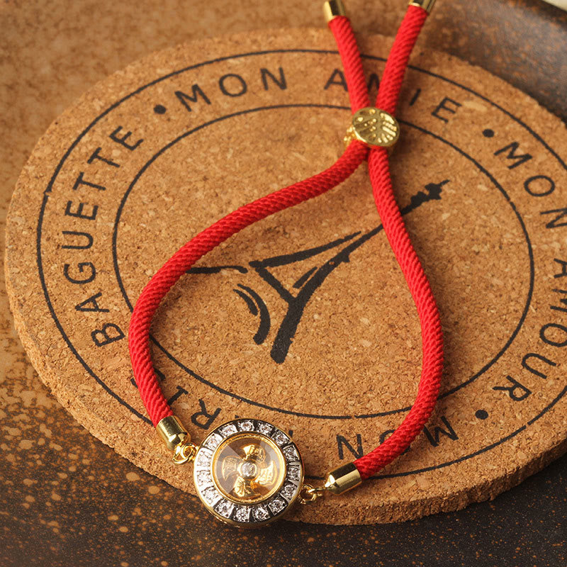 Bracelet de foi en fil rouge avec moulin à vent rotatif en cuivre et laiton