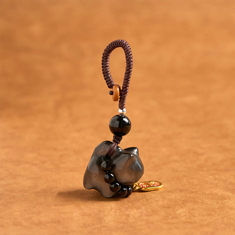 Porte-clés de protection en obsidienne argentée avec le personnage Fu