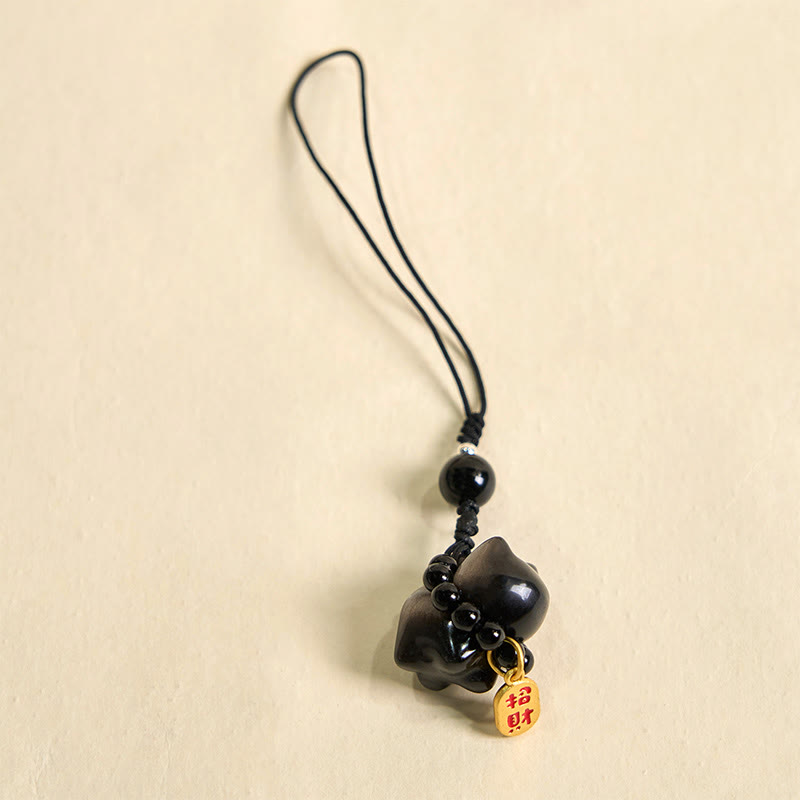 Porte-clés de protection en obsidienne argentée avec le personnage Fu