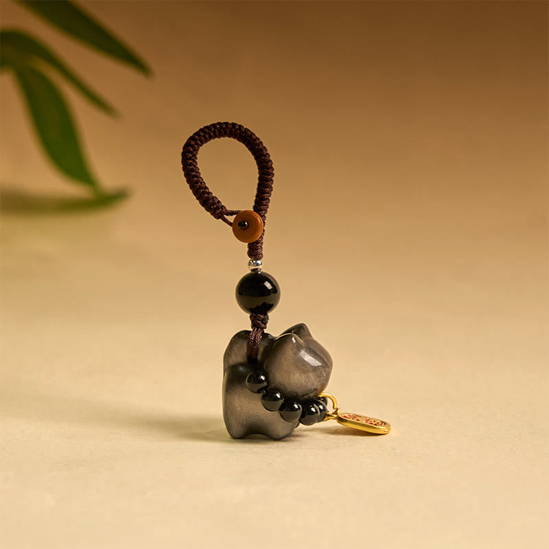Porte-clés de protection en obsidienne argentée avec le personnage Fu