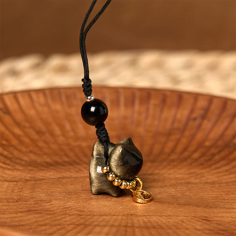 Porte-clés de protection en obsidienne argentée avec le personnage Fu