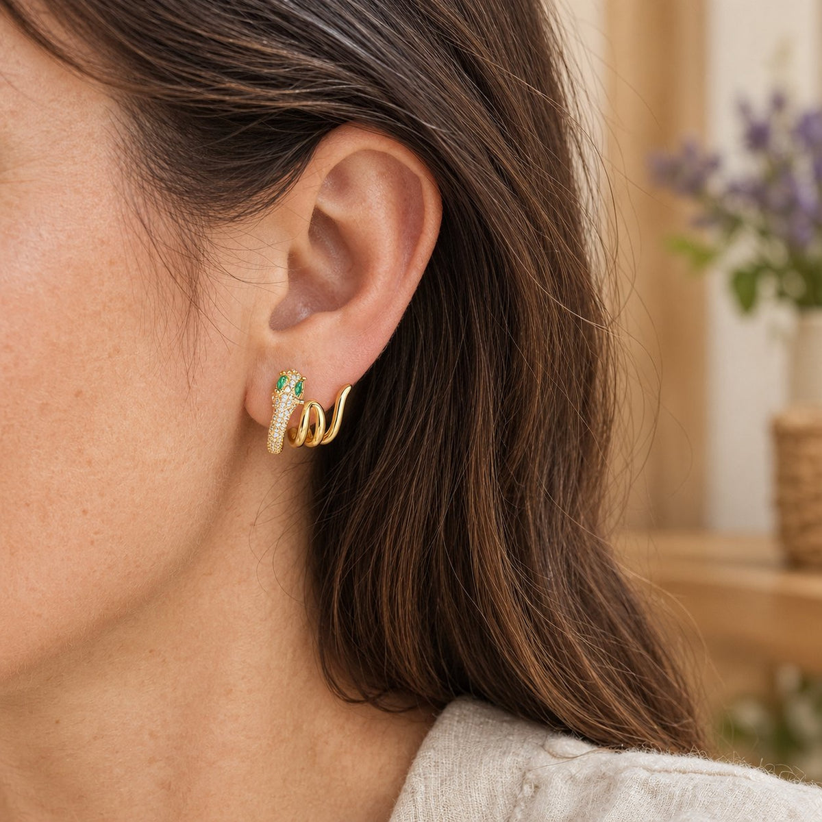925 Sterling Silver Green-eyed Snake Earrings for Harmony, worn on the ear by a woman