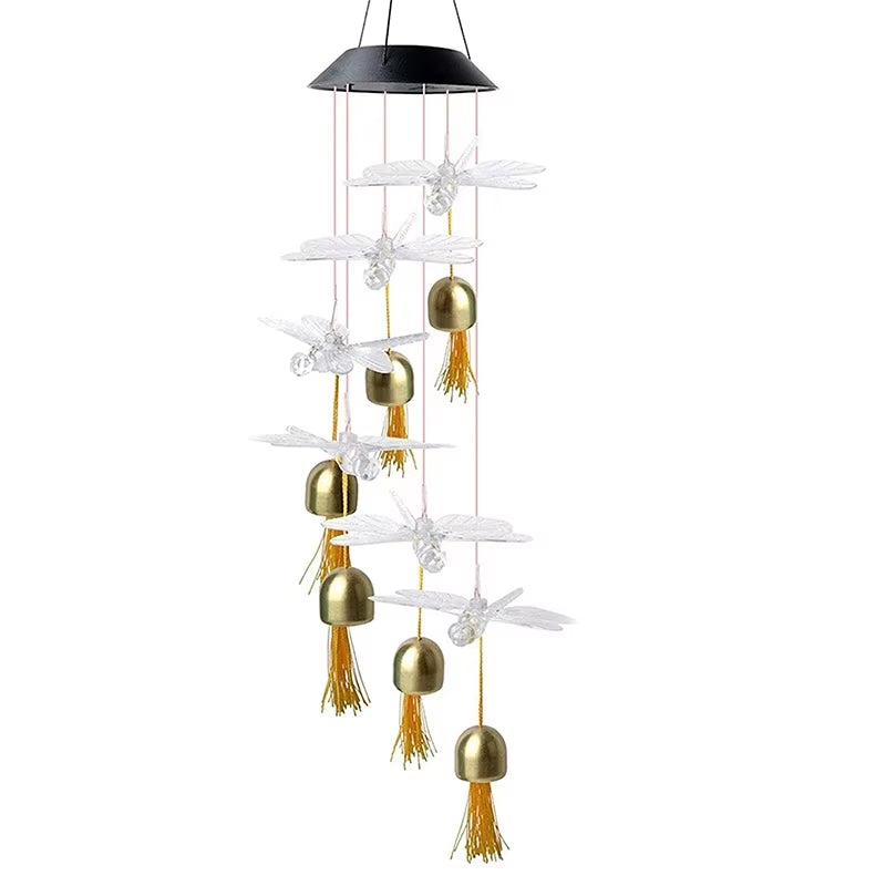 Solar Dragonfly Wind Chime with golden bells and white dragonfly decorations outdoors