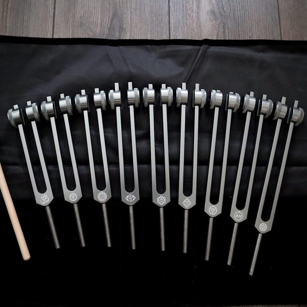 Row of Solfeggio tuning forks in a curved formation for chakra healing