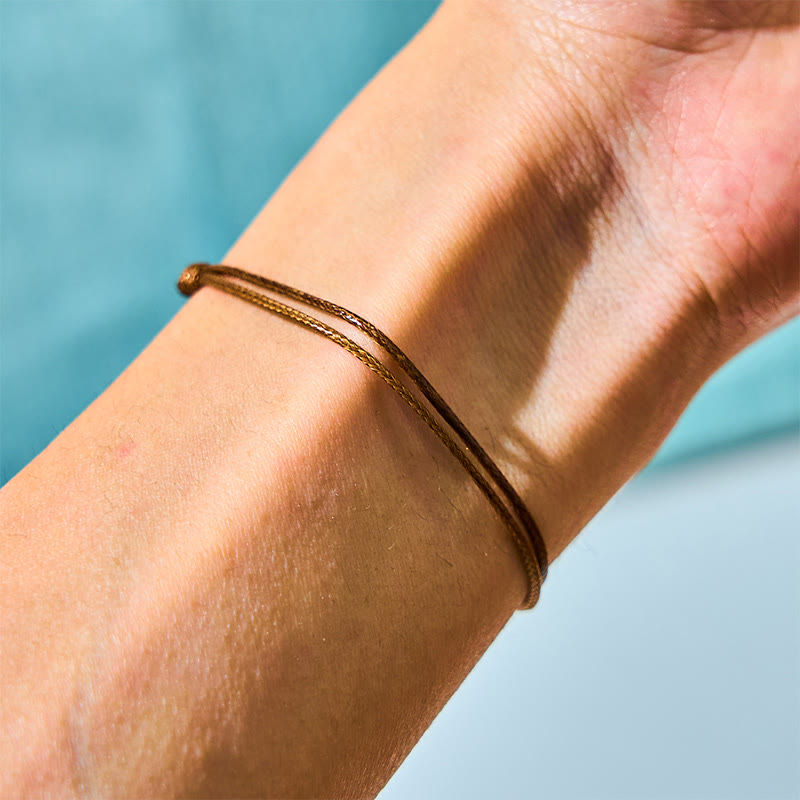 Bracelet de guérison en perles noires de Tahiti sur corde cirée 14-19 cm