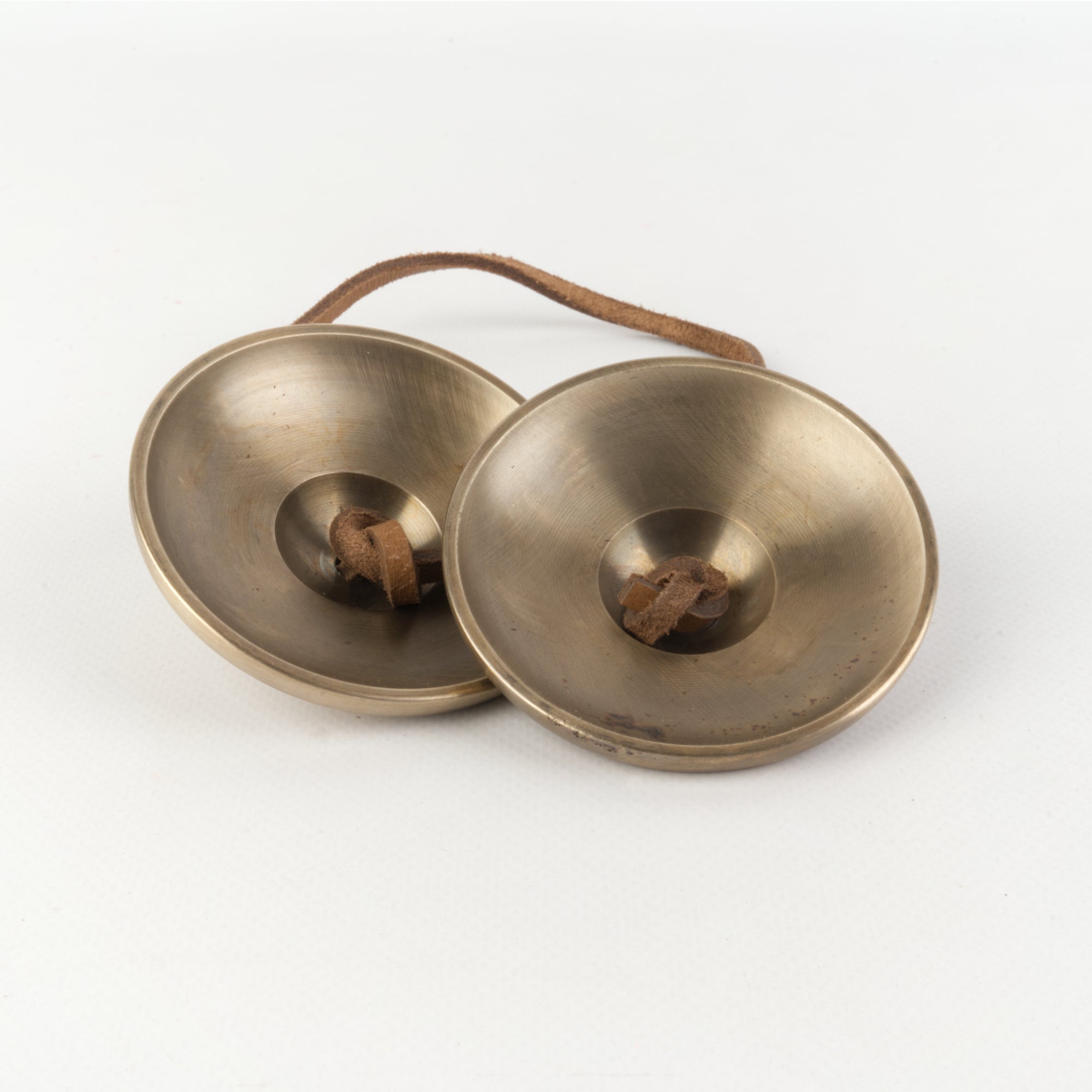 Brass finger cymbals with leather strap from Therapy Grade Tibetan Tingsha collection