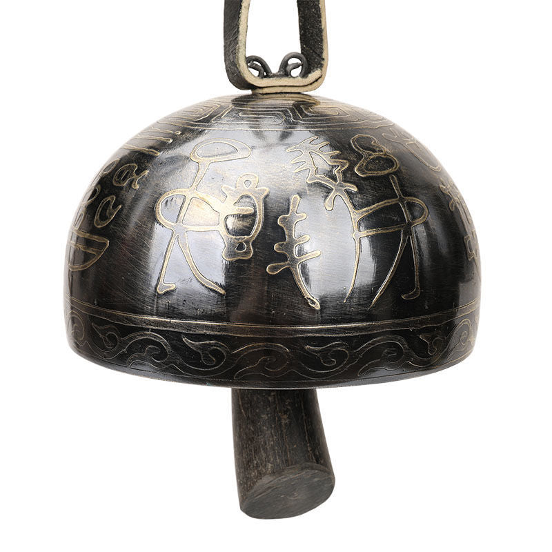 Dark metal Tibetan meditation bell with decorative etched dome designs for relaxation