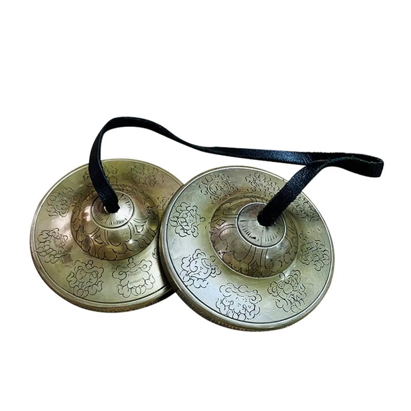 Traditional Tibetan Tingsha cymbals with etched patterns for meditation and sound healing