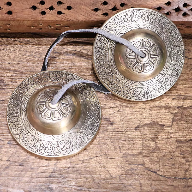 Traditional Tibetan Tingsha Bells for meditation with intricate floral engravings
