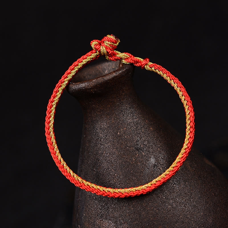 Bracelet bicolore artisanal à huit fils avec nœud de paix rouge