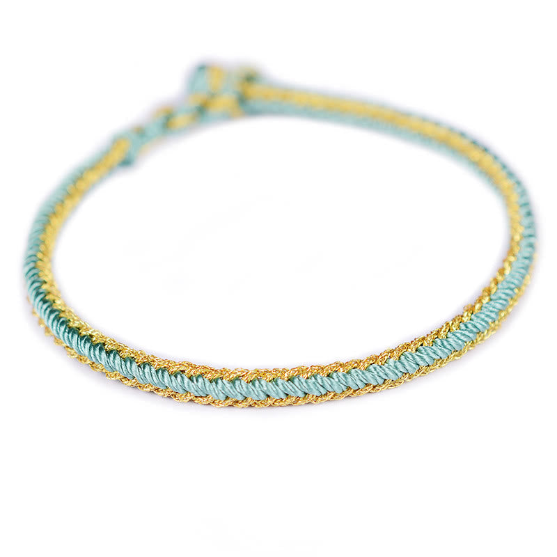 Bracelet bicolore artisanal à huit fils avec nœud de paix rouge