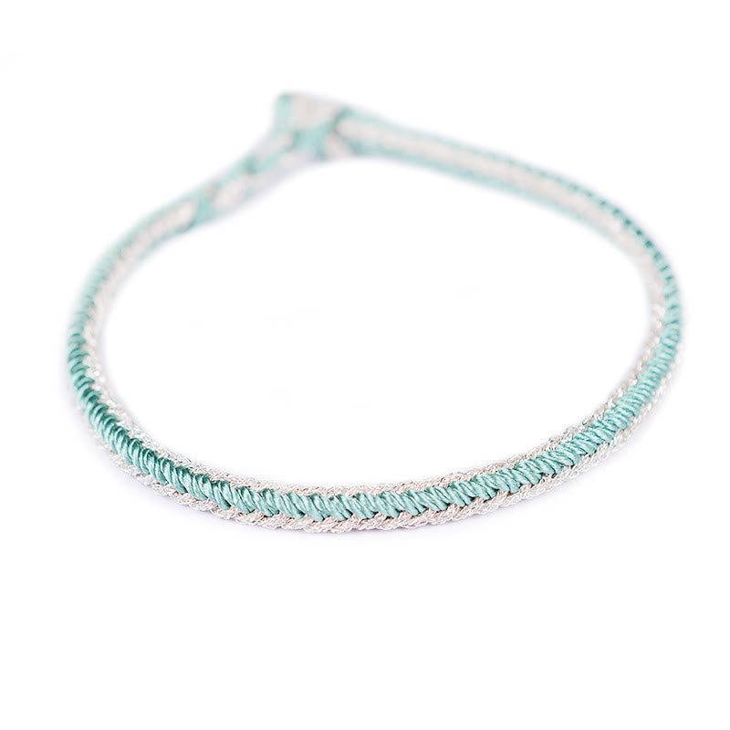 Bracelet bicolore artisanal à huit fils avec nœud de paix rouge
