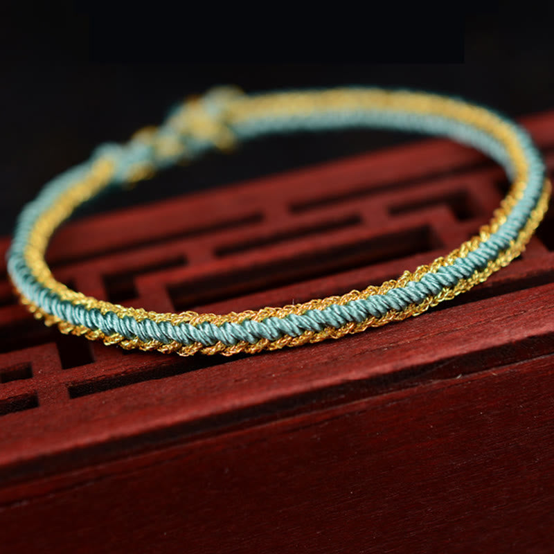Bracelet bicolore artisanal à huit fils avec nœud de paix rouge