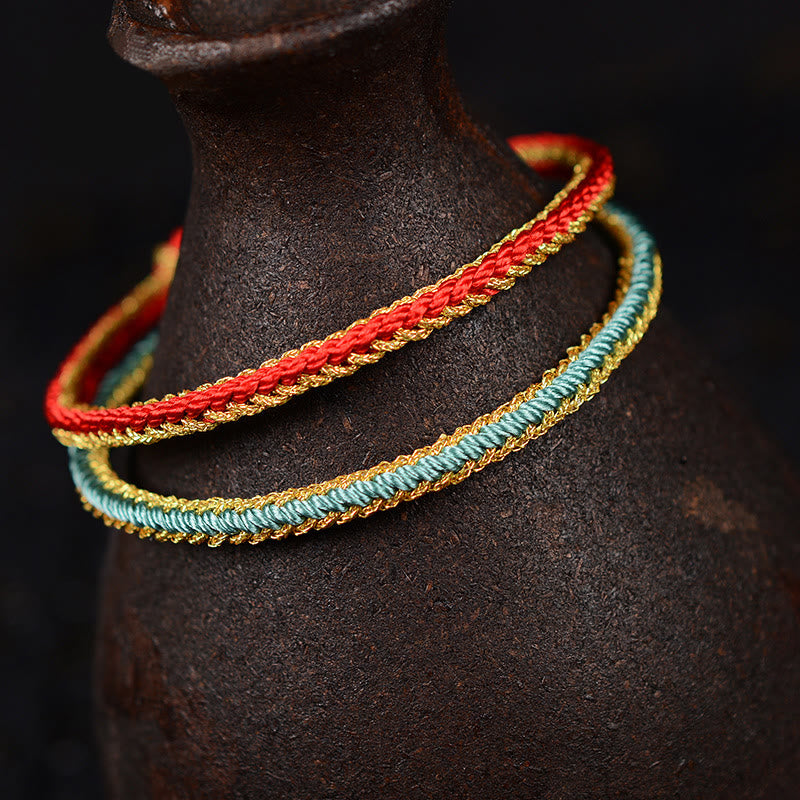 Bracelet bicolore artisanal à huit fils avec nœud de paix rouge