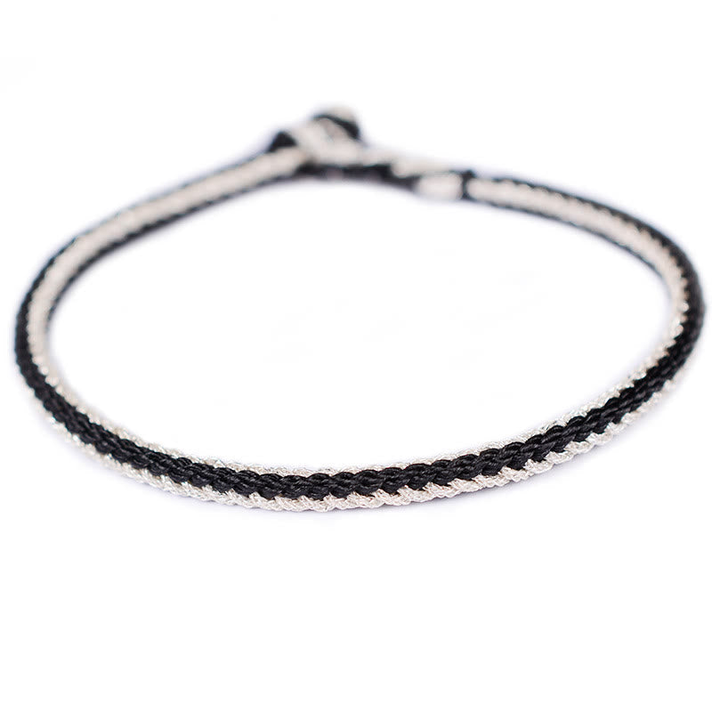 Bracelet bicolore artisanal à huit fils avec nœud de paix rouge
