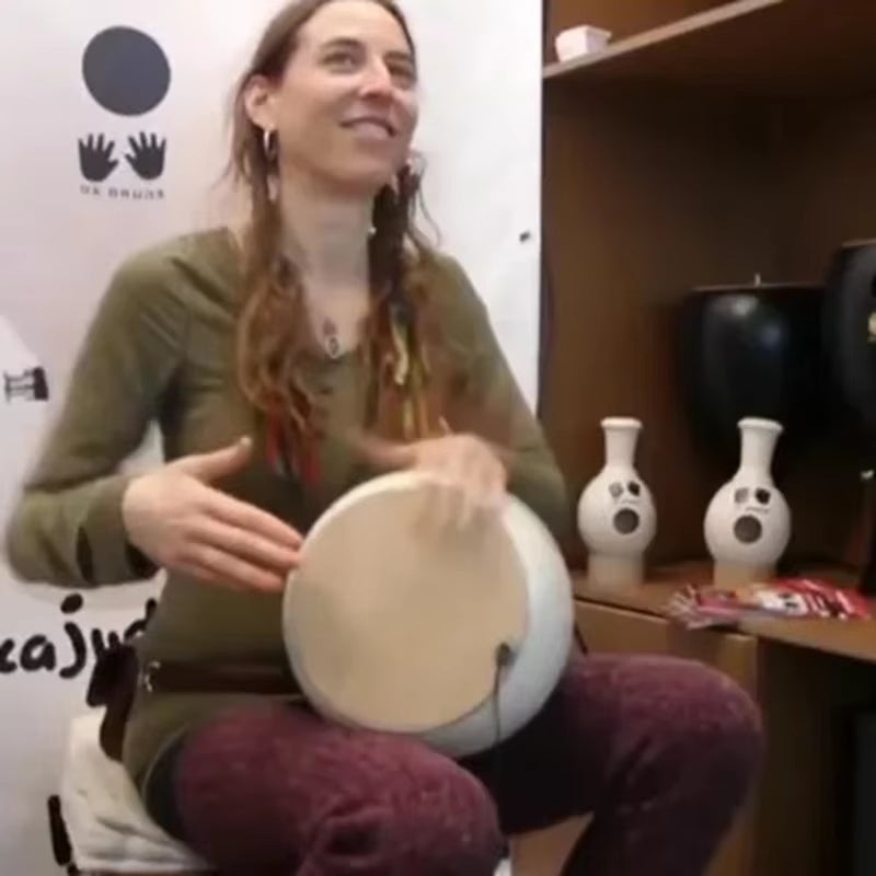 Handheld frame drum being played, showcasing Udu Drum African Clay Percussion