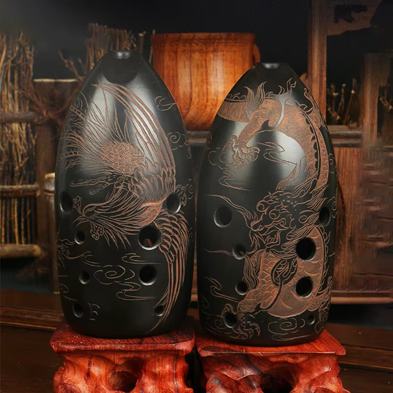 Two black ceramic vases with phoenix and dragon designs on red stands for Vintage Dragon Phoenix Xun Instrument